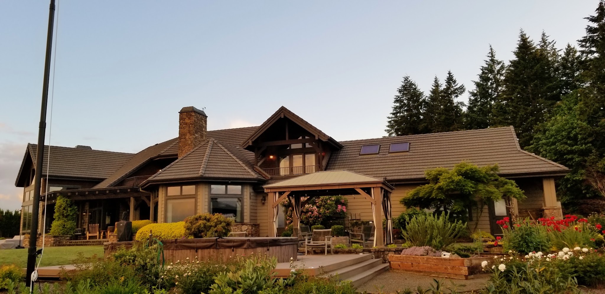 Completed exterior cleaning on a large home at dusk